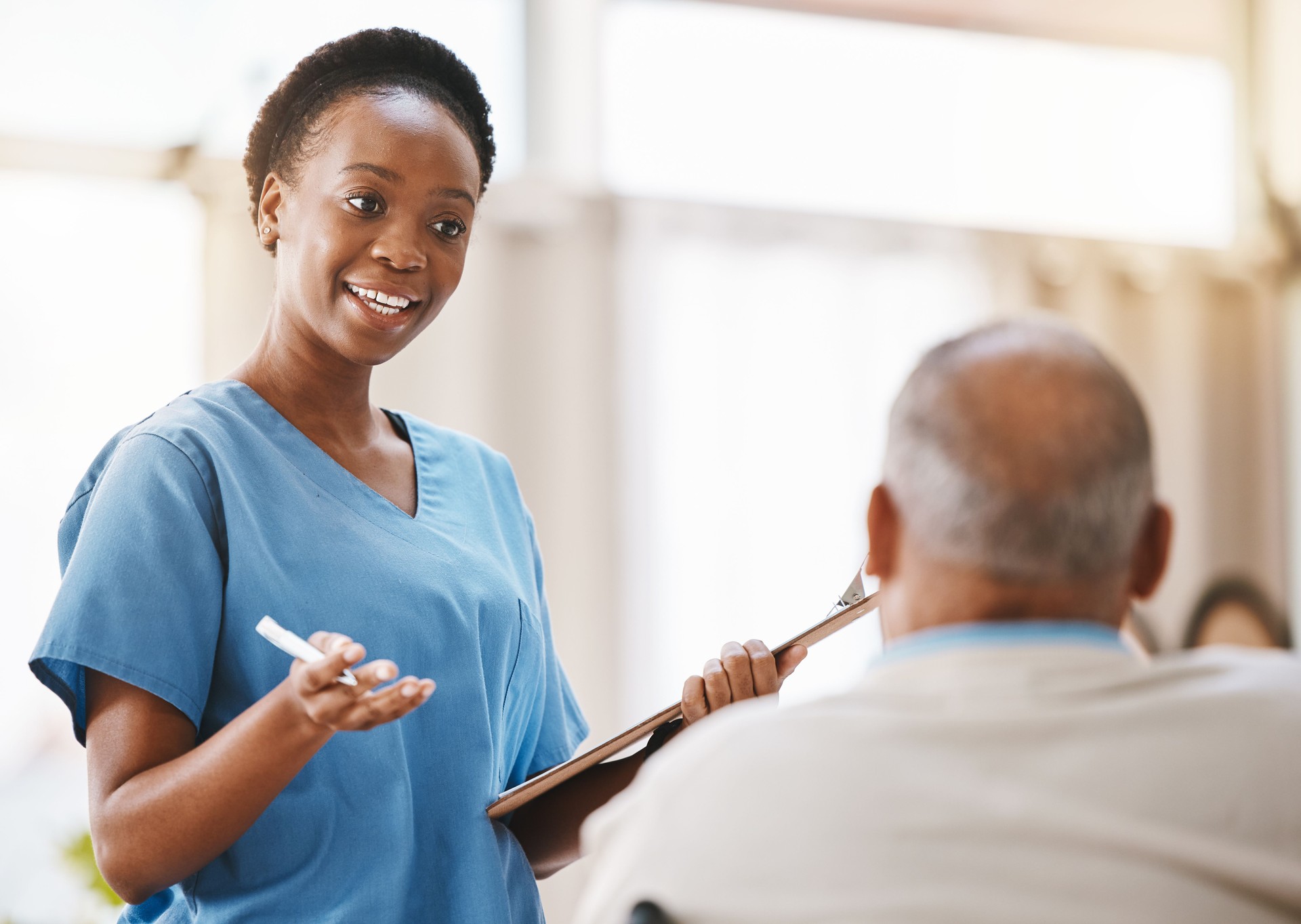 Consulting, medical and checklist with old man and nurse for retirement, rehabilitation or physical therapy. Help, empathy and healing with patient and black woman in nursing home for healthcare exam